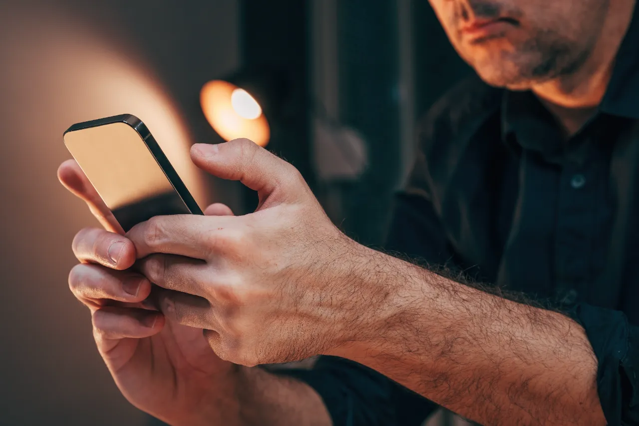 businessman using mobile smartphone with both hand utc