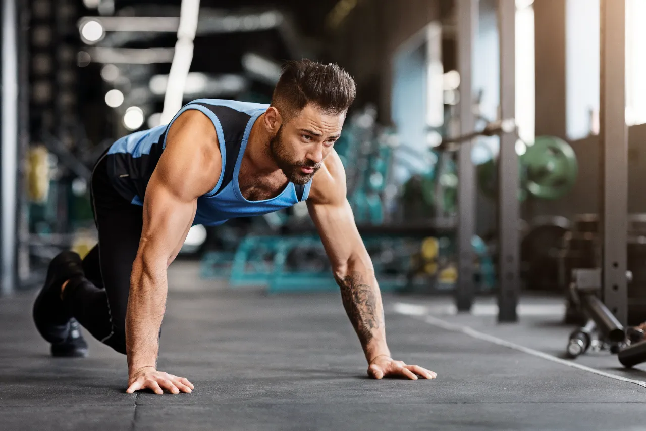 muscular guy preparing for hard workout in gym utc